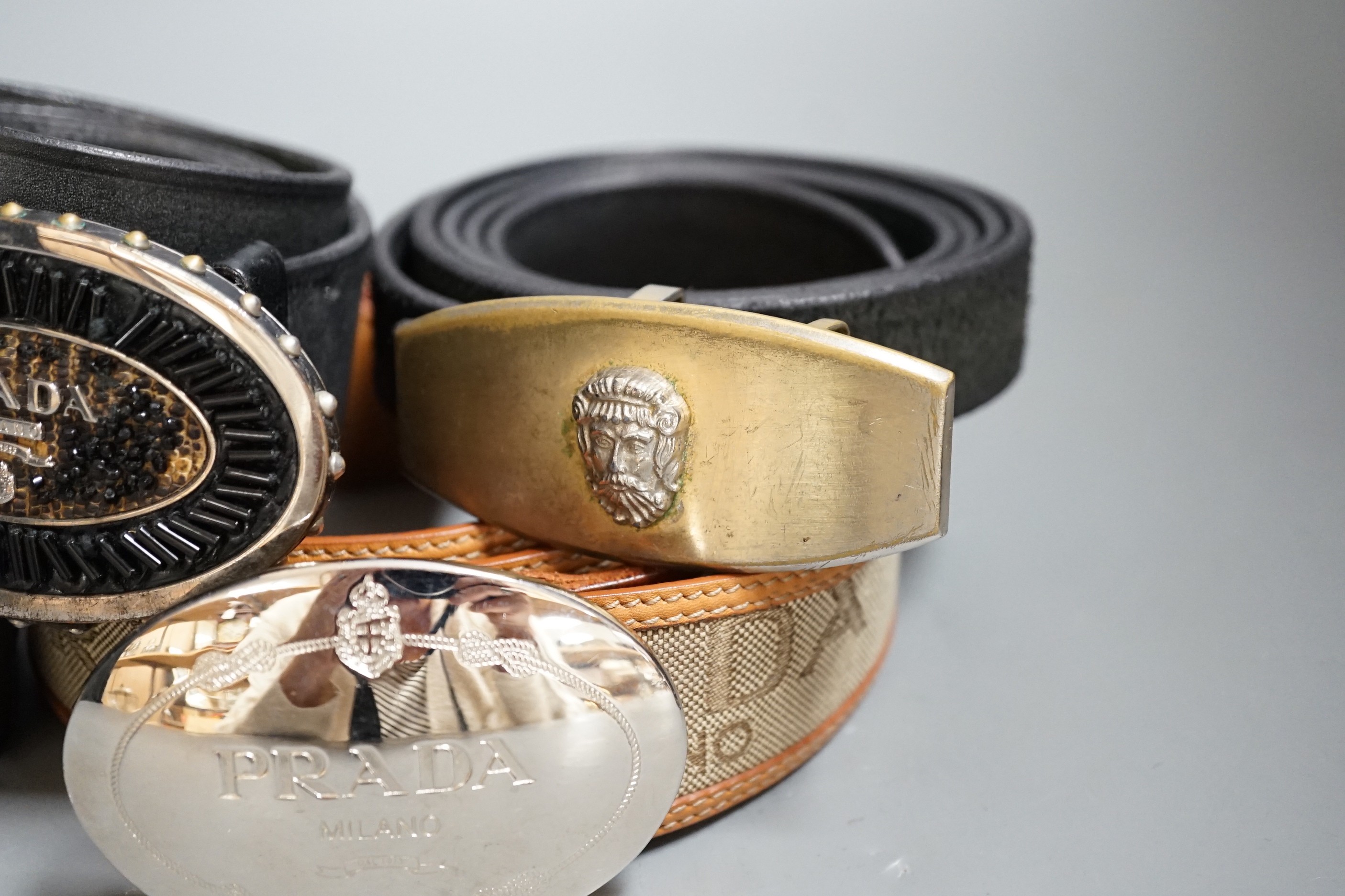 Five assorted belts including Prada (2) and Versace (2)